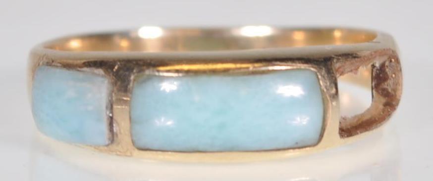 A stamped 14ct gold ring set with blue stone panels to the head. Weight 2.2g. Size N. Please note