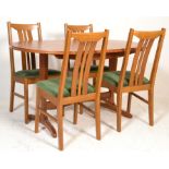 A retro 20th century  teak wood dining table and chairs. The 4 chairs with matching extending dining