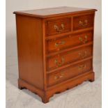 A Georgian mahogany  and yew wood inlaid revival bachelors chest of drawers being raised on a plinth