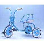 A vintage 1950's tubular metal childs trike  in the original blue colourway with pedals and original