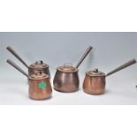 A collection of Victorian 19th century brass pans and pots to include 2 saucepans with lids together