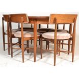 A mid century retro 1970's G-Plan teak wood extending dining table and chairs suite. Raised on