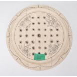 A 20th century faux ivory / ivorine resin scrimshaw solitaire board of circular form being decorated