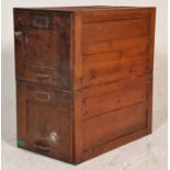 An early 20th century Industrial office pine filing cabinet having stacking twin sections with