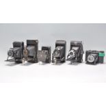 A collection of six vintage folding bellows cameras to include a Agfa Compur, Coronet, Kodak vest