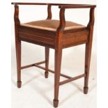 An Edwardian mahogany inlaid piano stool seat being raised on tapering legs with hinged seat