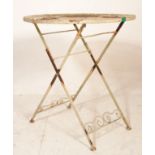 A mid Century vintage painted cast iron cafe / patio garden folding table with central iron work
