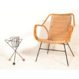 A mid century rattan weave and bamboo tropics chair raised on a metal tubular base with shape