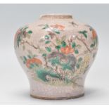 A small 18th Century Chinese vase with enamel crackle glazed ground and hand painted floral