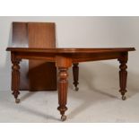 A Victorian 19th century mahogany twin leaf extending wind out dining table. Raised on reeded