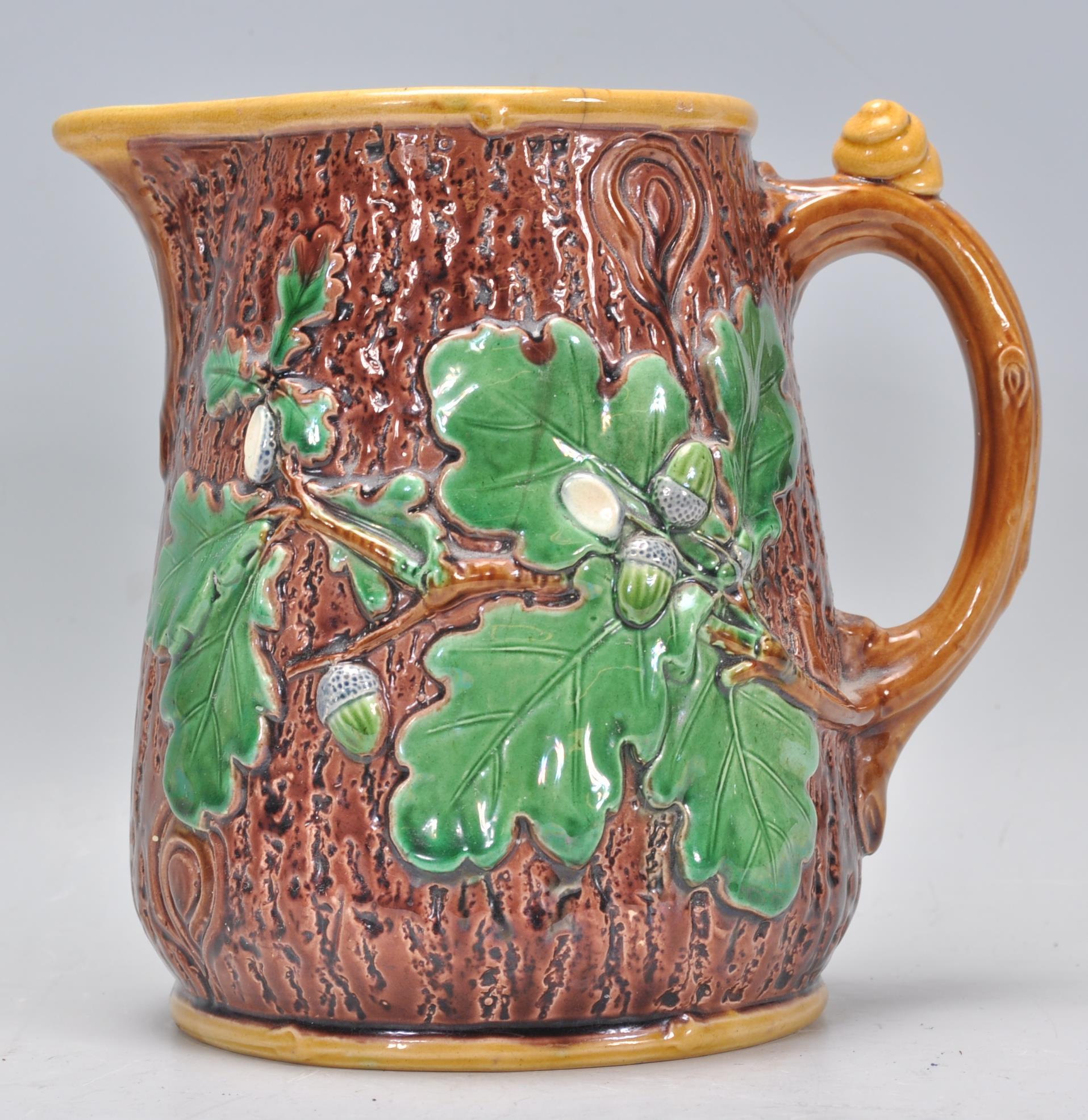 A 19th Century Victorian Mintons Majolica oak jug having a tree bark effect to the exterior with