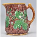 A 19th Century Victorian Mintons Majolica oak jug having a tree bark effect to the exterior with