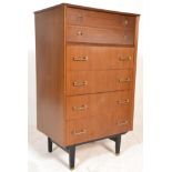 A vintage retro 20th Century teak chest of drawers having a two inset drawers with rounded brass