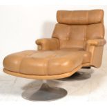 A retro 20th century large brown leather revolving armchair and ottoman footstool. Upholstered in