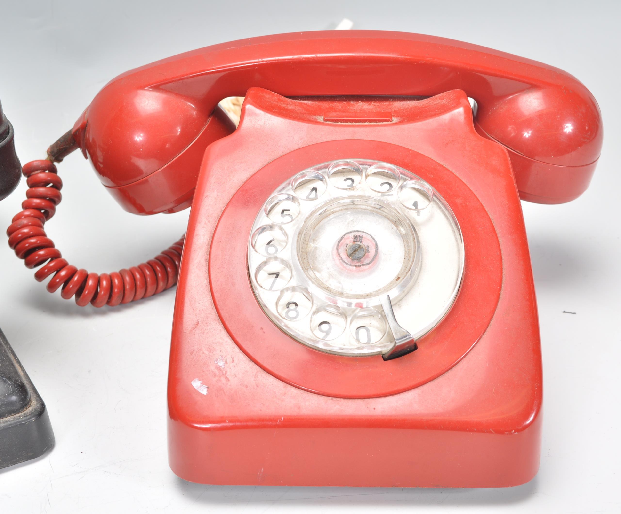 Two vintage 20th Century ring dial telephones to include a black bakelite example and a red - Image 3 of 4
