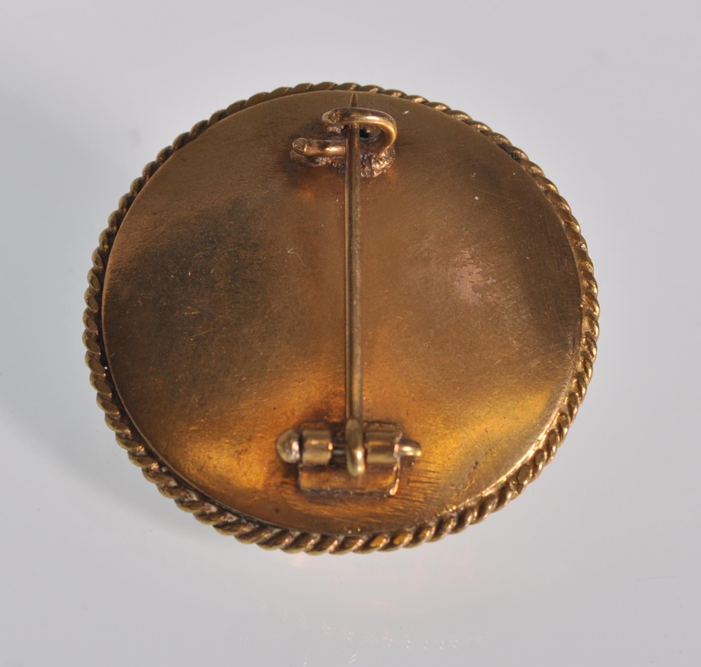 A 19th Century Victorian gold tone brooch of circular form with raised and engraved decoration - Image 3 of 3