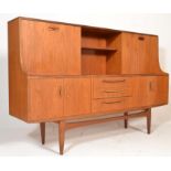 A mid century G-Plan teak wood sideboard credenza highboard raised on square tapering legs with a