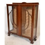 A 1940's Queen Anne revival mahogany china display cabinet vitrine being raised on bracket feet with