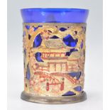 A large Chinese cup holder with intricate pierced decoration featuring pagoda's dragons and ladies