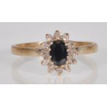 An English hallmarked 9ct yellow gold ladies ring set with a central faceted cut oval black stone