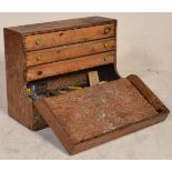 A mid 20th Century pine tool chest / workmans box having a half full front reveal a series of