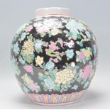 A large 20th century Chinese ginger jar of bulbous form having black ground with polychromatic