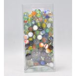 A collection of marbles to include glass cats eye marbles, some white and coloured glass examples,