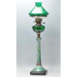 A large 20th century faux marble and green glass reservoir oil lamp with tall green faux marble