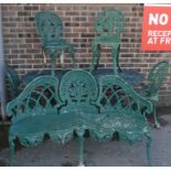 A 20th century Antique Victorian revival painted metal garden bench and table with chairs in the