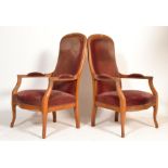 A pair of 1900's French walnut empire revival armchairs. Each raised on cabriole legs with shaped