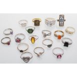 A selection of fourteen silver ladies rings to include a panel ring of square form set with blue