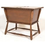 A late 19th century carved Arts & Crafts oak ladies work box - sewing box being raised on ring