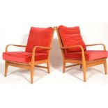 A pair of mid century bentwood Danish influence armchairs being raised on squared legs with bentwood