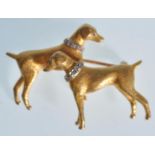 A hallmarked 9ct gold dog brooch in the form of two Doberman's set with diamond collars.