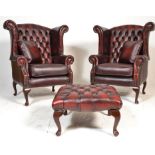 A pair of 20th Century Antique style red oxblood  leather Chesterfield button back wing armchairs