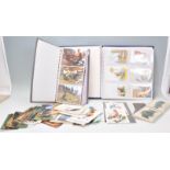 A collection of vintage postcards spanning two albums with some loose examples to include multiple