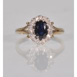 A hallmarked 9ct gold ladies dress ring having a split shank set with an oval cut sapphire with a