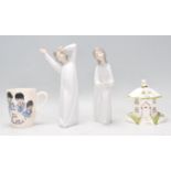 A pair of Lladro porcelain figurines, each of children in night gowns being stamped to the base