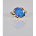 A stunning 9ct yellow gold and black opal ladies dress ring set with an oval cut black opal cabochon
