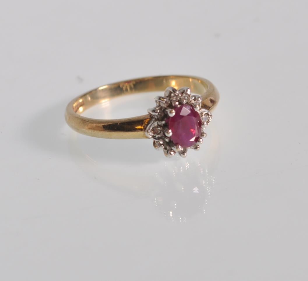 A hallmarked 9ct gold diamond and garnet flower head ring having a central faceted red stone with - Image 2 of 6