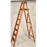 A vintage early 20th Century wooden Industrial folding step ladder / shop display having six