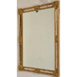 A 20th century Antique style gilt rococo wall mirror having a gilded frame with pierced centre,