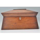 A 19th Century Georgian mahogany tea caddy of sarcophagus form having an ivory key escutcheon. The