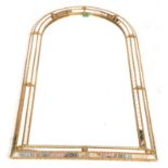 A 20th century Venetian gilt mirror of arched form with cushion border adorned qwith multiple mirror