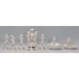 A collection of Italian porcelain cherub figurines to include oyster shell table salts, solifleur