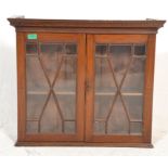 A 19th century Victorian mahogany and line inlaid astragal glazed hanging bookcase cabinet. Twin