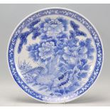 A 19th century Chinese blue and white charger plate with unusual scene of eagle within foliage and