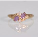 An English hallmarked 9ct yellow gold ladies dress ring set with two teardrop purple stones with two