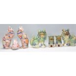 A set of four graduating Chinese fu / foo temple dogs being green and yellow / Sancai glazed