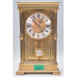 A vintage 20th Century Acctim mantel clock having a brushed brass case with turned columns with a